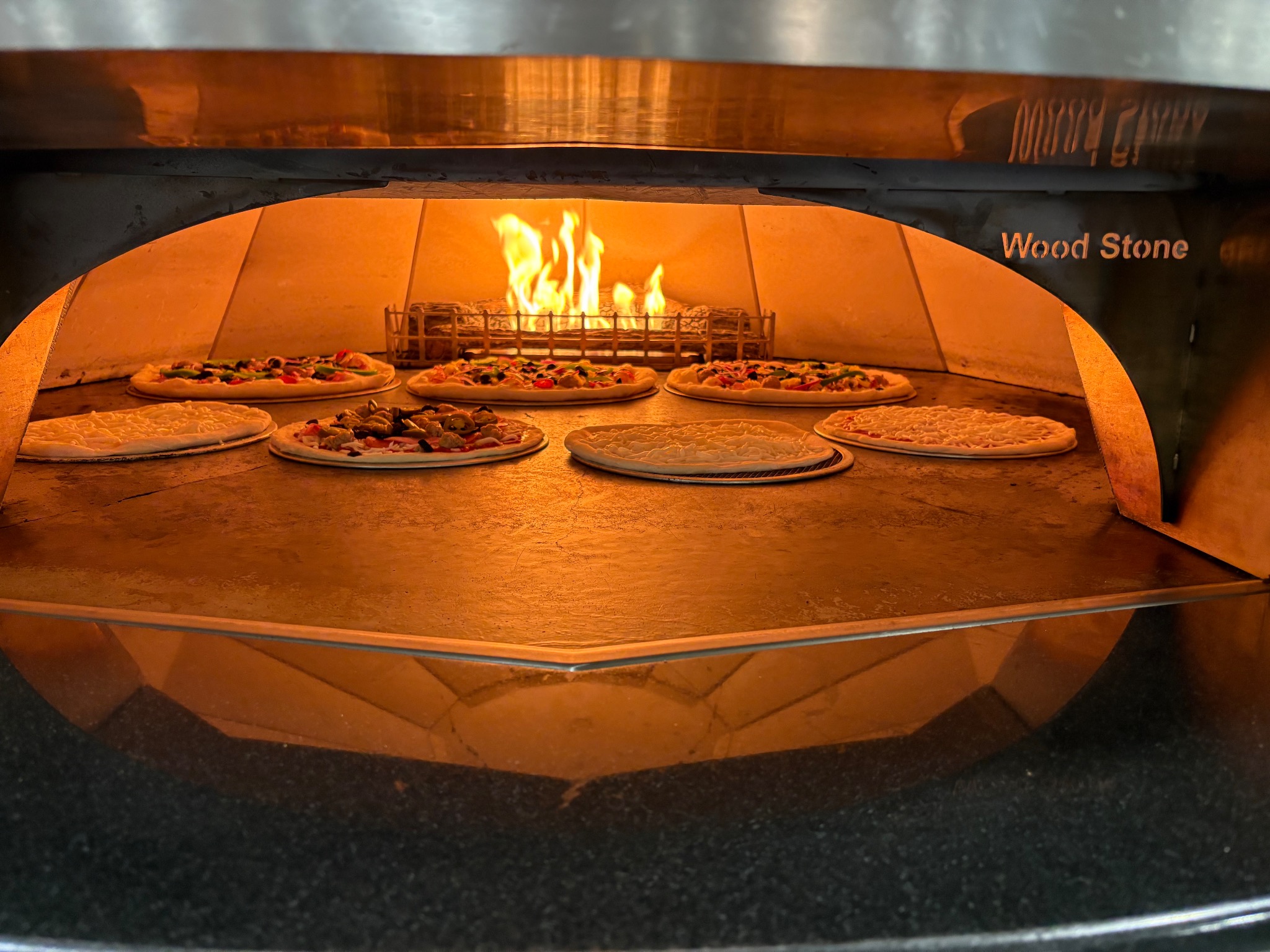 Multiple pizzas baking inside the Wood Stone oven