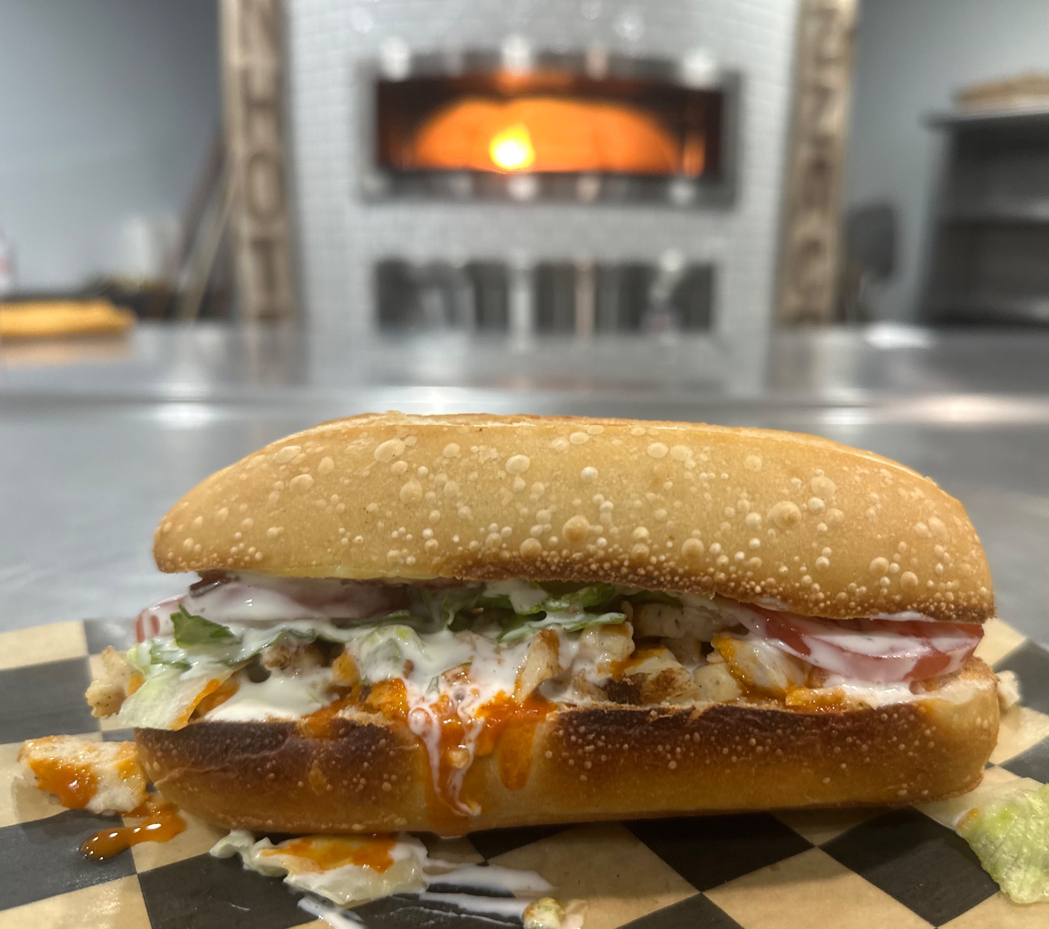 Buffalo-style sandwich in front of the oven